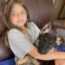 Young child hugging a German Shepherd puppy with love and joy